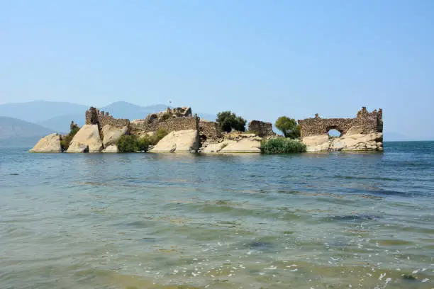 Photo of Island with ancient fortifications in Kapikiri village on Bafa lake in Mugla, Turkey.