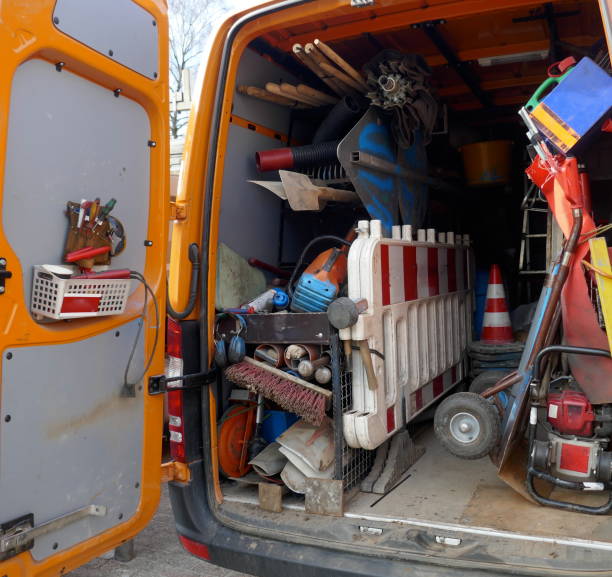 istock Cargo space of a construction vehicle, loaded with various tools, transport cart, barriers, shovels and brooms 1129204726