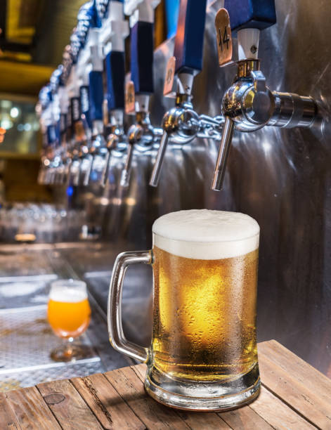 istock Frosty mug of light beer on the old wooden table. 1129207059