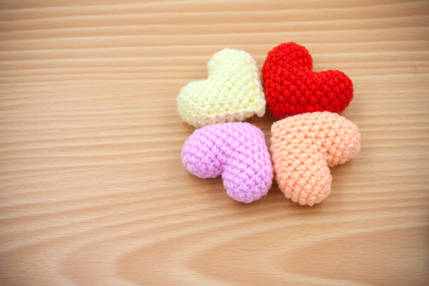 istock High Angle View Of Multi Colored Woolen Heart Shapes On Wooden Table 1129207656