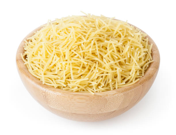 istock Uncooked vermicelli pasta in wooden bowl isolated on white background with clipping path 1129207848