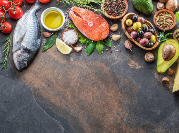 istock Raw dorado fish and salmon steak with spices and vegetables. 1129211128