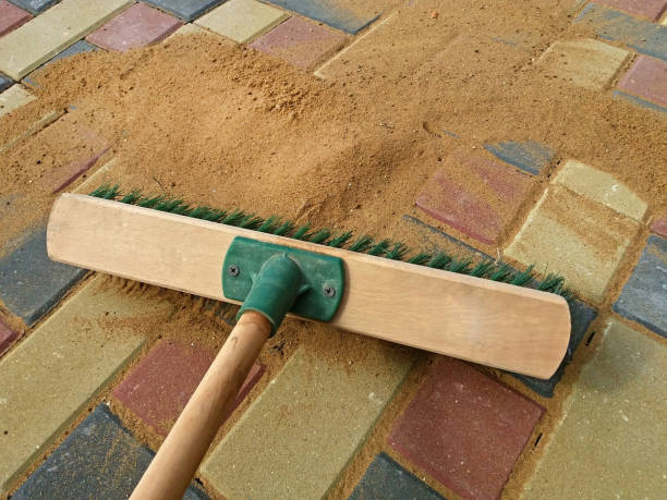 istock Filling paving joints, Brushing dry sand. Finishing work 1129211840