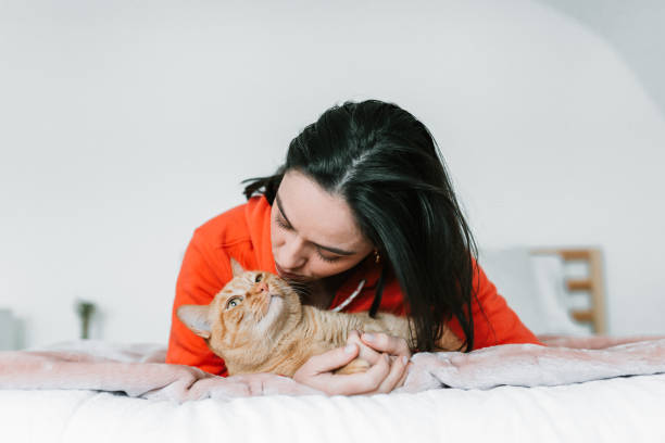 istock Young woman with her cat in bed 1129211845