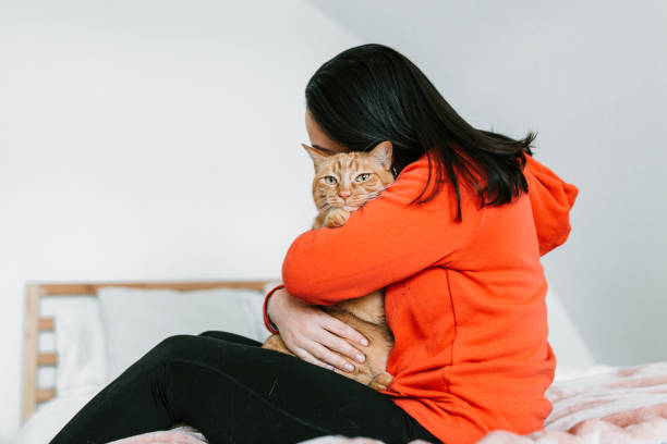 istock Young woman with her cat in bed 1129211882