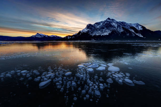istock Sunrise with ice bubbles, Abraham Lake, Clearwater County, AB, Canada. 1129212993