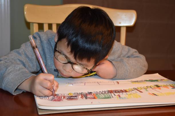 istock Series 1: Intelligent Little Boy Coloring Trains 1129220188