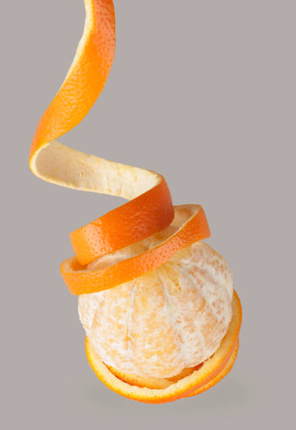 istock wrap orange peel, spiral winding on fruit, on gray background 1129221765