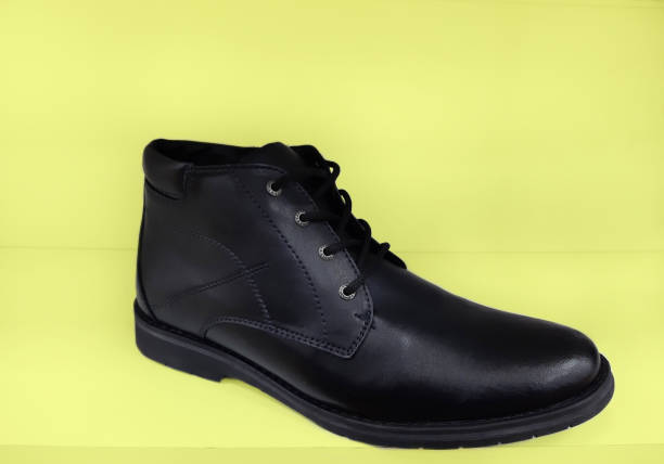 istock Winter shoes on yellow background close up 1129222783