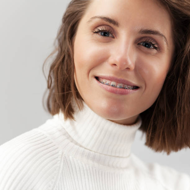 istock Young beautiful woman with braces 1129222923
