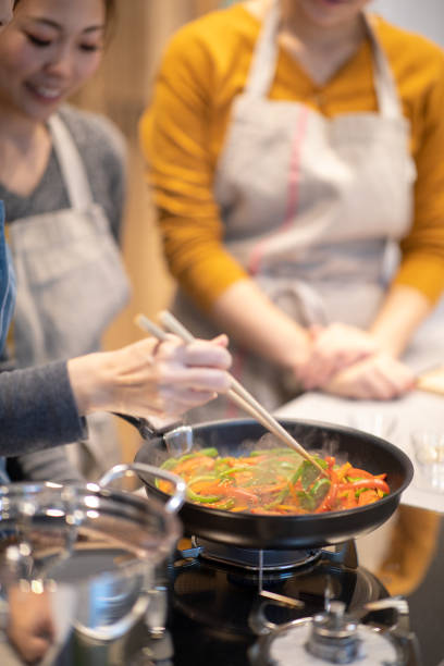 Sauteing vegetables at cooking school