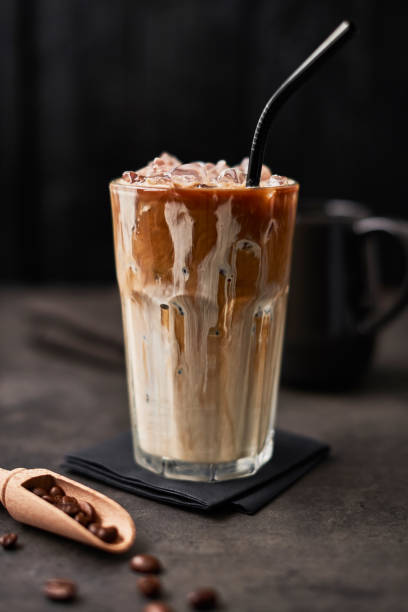 istock Ice coffee with cream in a tall glass with straw 1129231017