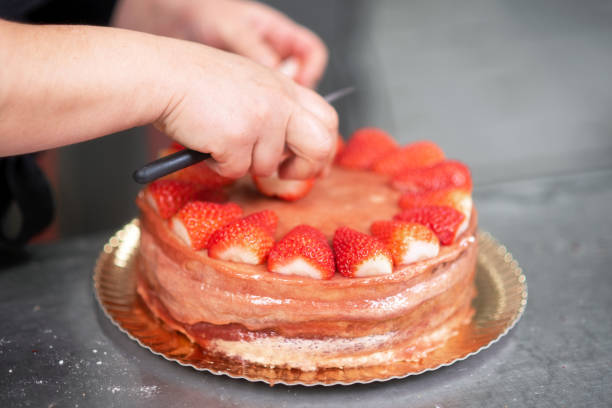 istock Pastry Chef making a delicious strawberry cake 1129232069