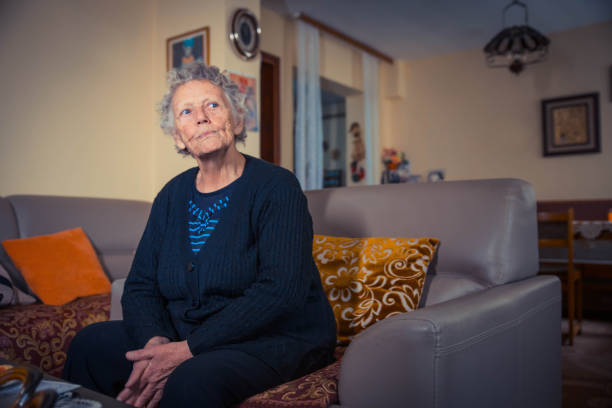 istock Elderly woman at home sitting 1129234063
