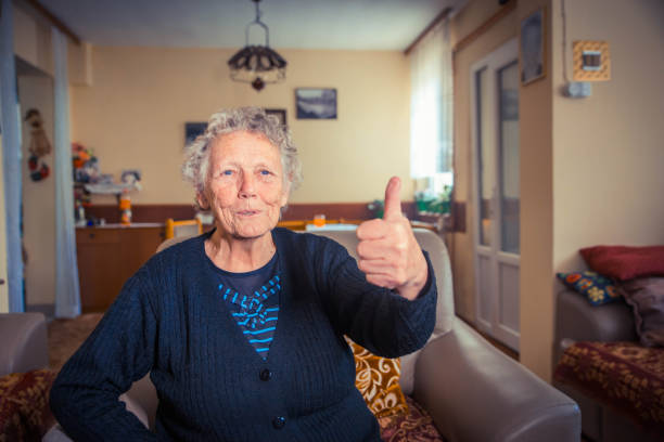 Smiling senior man posing with his thumb up