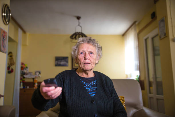 istock Senior woman with TV remote 1129234104