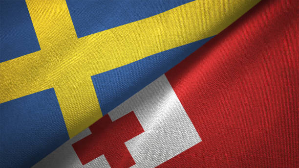 istock Sweden and Tonga two flags textile cloth, fabric texture 1129235673