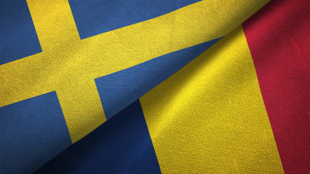 istock Sweden and Chad two flags textile cloth, fabric texture 1129235706