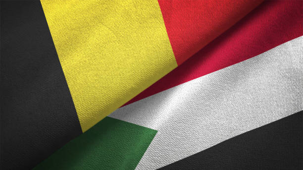 istock Belgium and Sudan two flags textile cloth, fabric texture 1129238582