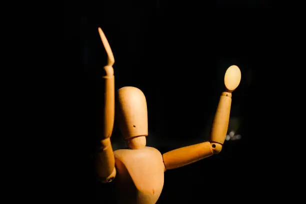 Wooden mannequin model with hands up