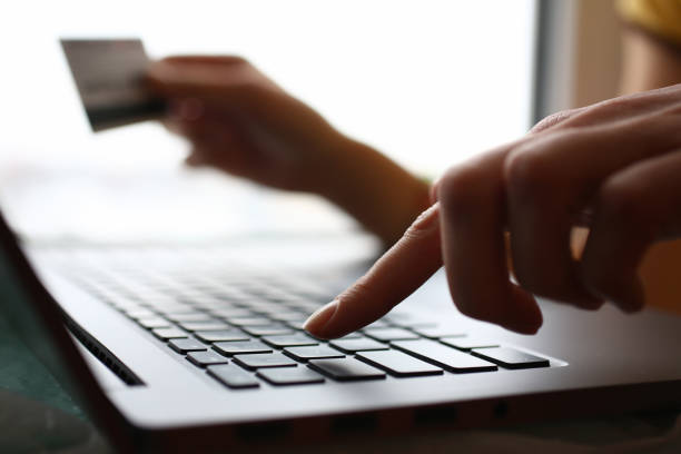 istock Male arms hold credit card press buttons 1129246785