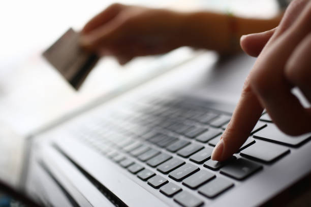 istock Male arms hold credit card press buttons 1129246786
