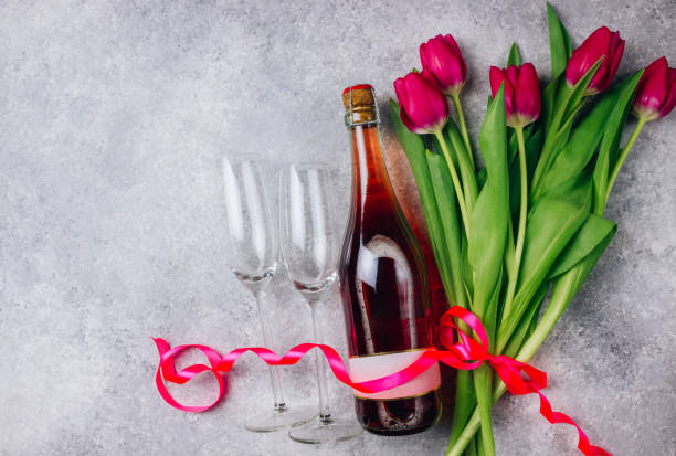 istock Tulips, champagne bottle and two empty glasses 1129248022