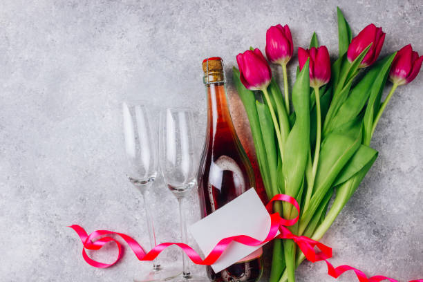 istock Tulips, champagne bottle and two empty glasses 1129248026