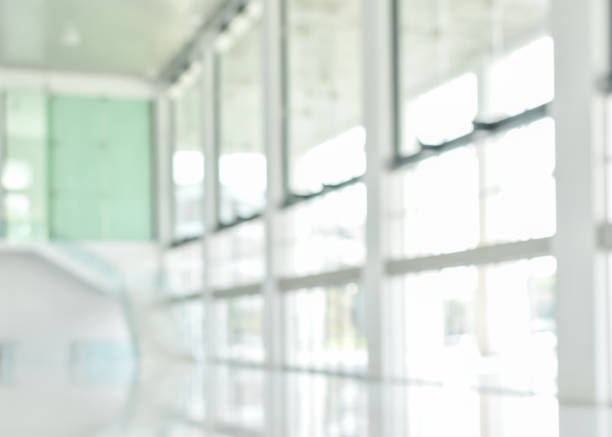 istock Business building blur background office lobby reception hall interior or empty indoor foyer room with blurry light from glass wall window 1129248335