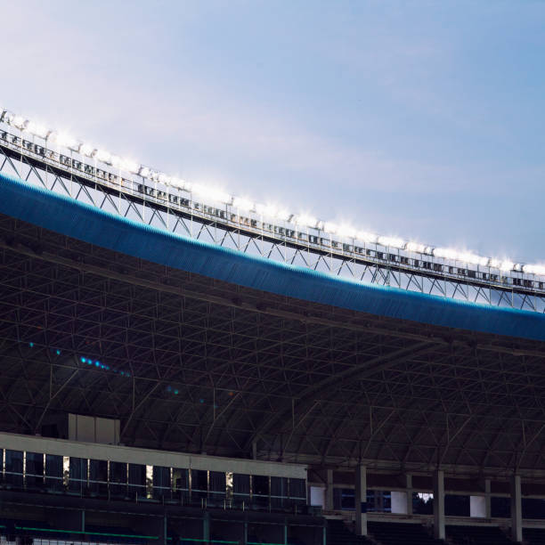 istock Spotlights and floodlights at a stadium at dusk 1129249742