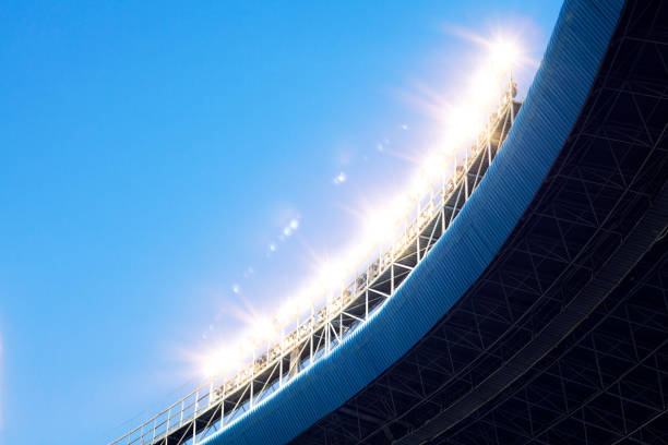 istock Spotlights and floodlights at an empty stadium at dusk 1129249787