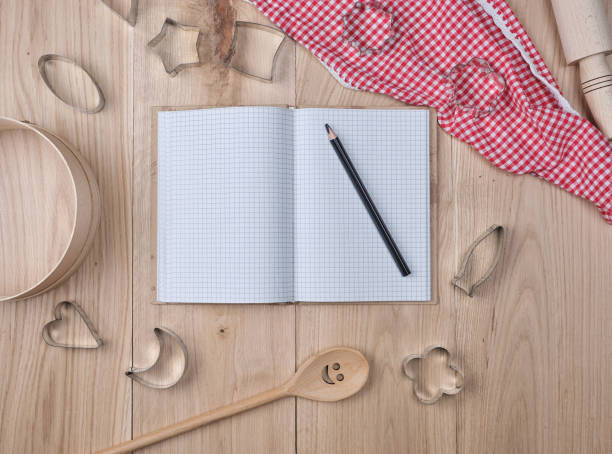 istock blank open notebook in line and wooden kitchen accessories 1129250569