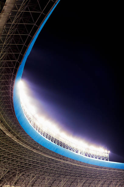 istock Floodlights at an empty stadium in China at night 1129251425
