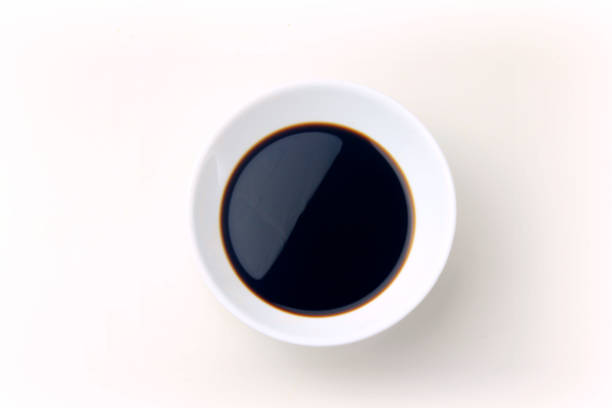 istock Soy sauce in a ceramic bowl isolated on white background, with clipping path. Copy space 1129252373