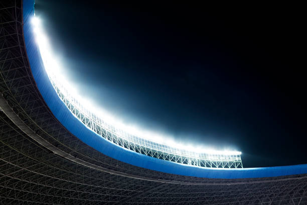 istock Spotlights and floodlights at a stadium at night 1129252507