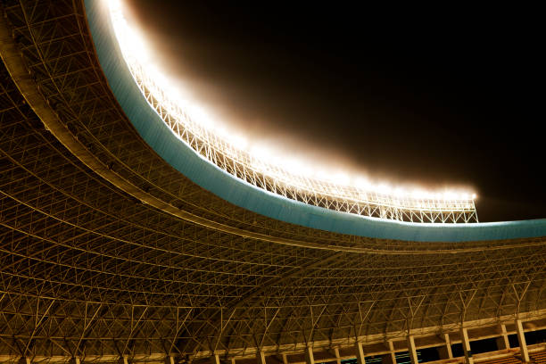 istock Spotlights and floodlights at a stadium at night 1129252518