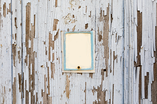 Blank sign on the rustic white wood wall