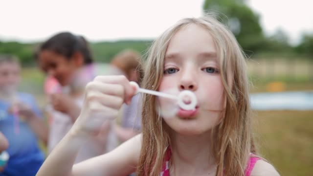 Mischievous Girl Blowing Bubbles