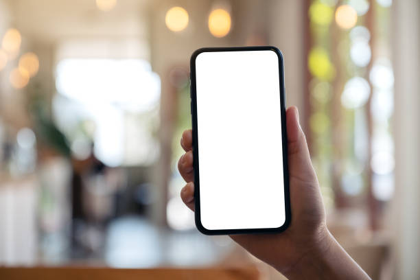 istock a hand holding and showing black mobile phone with blank white screen i 1129255628