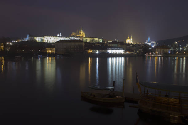 istock Vltava river, boats and Prague castle after dark 1129256727