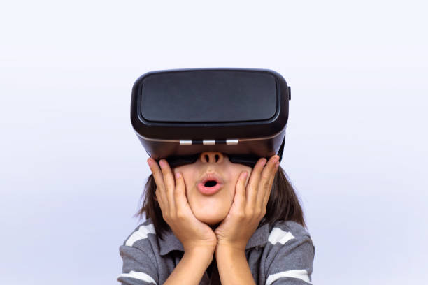istock Little boy playing video games with VR. 1129258963