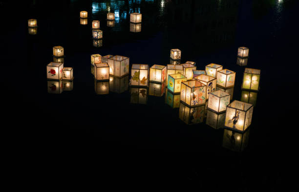 Kanazawa, Japan - June 3, 2016: Candle-lit lanterns drift down the Asano River in Kanazawa during the Kaga-yuzen (silk textiles) Tōrō Nagashi (floating of lanterns). The Kaga-yuzen Tōrō Nagashi is part of the annual three-day Hyakumangoku Festival, which commemorates Lord Maeda Toshiie’s entry into Kanazawa Castle on June 14, 1583. During the Maeda family's rule, which lasted for almost three hundred years, Kanazawa prospered and became a major cultural hub.