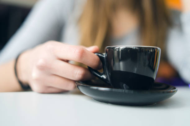 istock Close Up on Hand Holding a cup of Coffee 1129259575