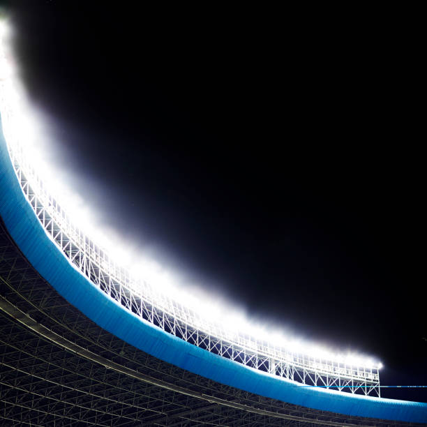 istock Spotlights and floodlights at a stadium at night 1129259944