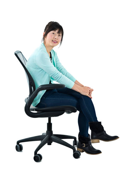 istock Woman sitting on office chair 1129269570