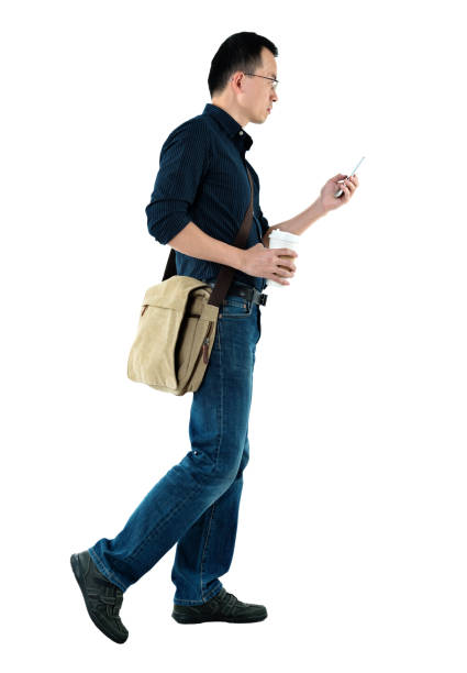 istock Businessman walking and using mobile phone 1129270709