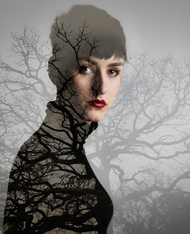 Multiple exposure image of woman morphing into nature