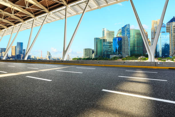 istock Asphalt road through Shanghai Lujiazui Financial District 1129274744