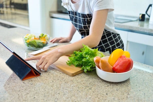 istock Woman hand searching for recipes online 1129274746