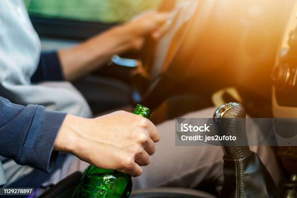 Drinking And Driving Man Drinking Alcohol And Using Mobile Phone While Driving Car Concept Drive Safely While Using A Cell Phone Or Drunk Alcohol Stock Photo - Download Image Now